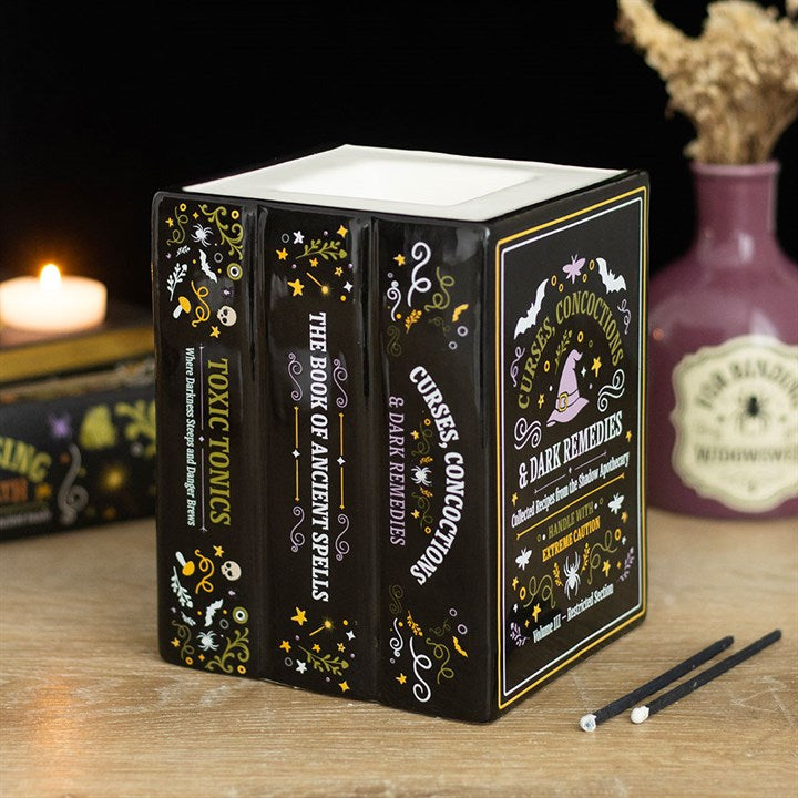 Quemador de aceite y calentador de cera con forma de libro de la botica de la bruja
